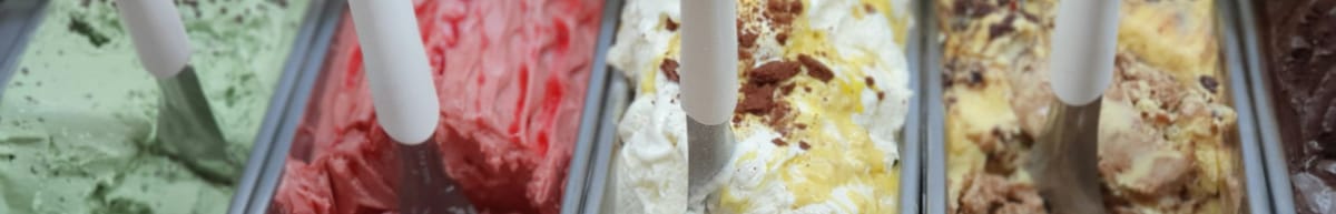 A row of ice cream tubs in different colours, each with a scoop sticking in the top.