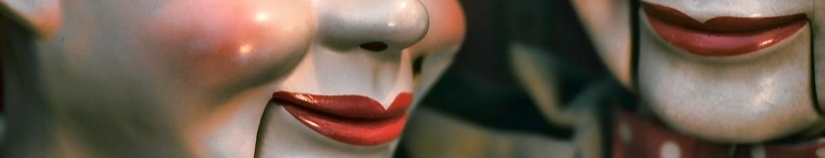 The creepy red mouths of two ventriloquist's dummies.